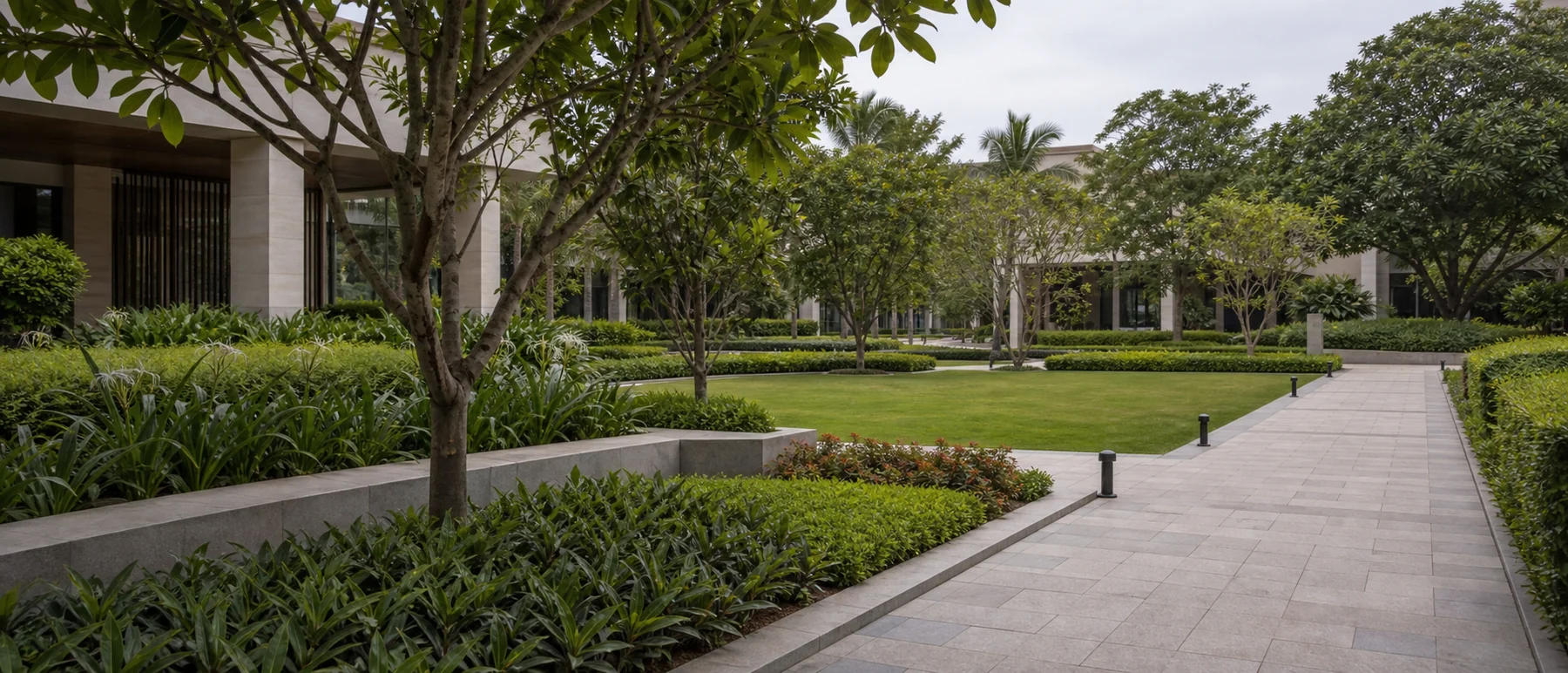 Bengaluru commercial landscaping with layered greenery, pedestrian routes, and year-round planting structure.
