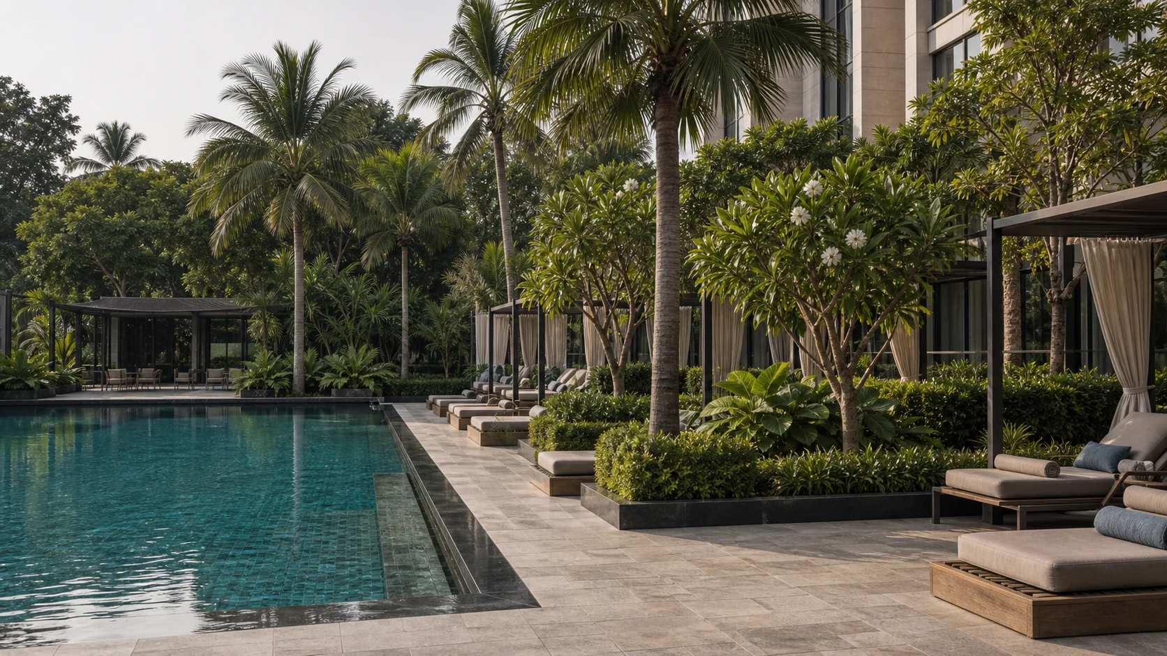 Hotel garden pathway with tropical planting, evening lighting, and refined pedestrian guest experience.
