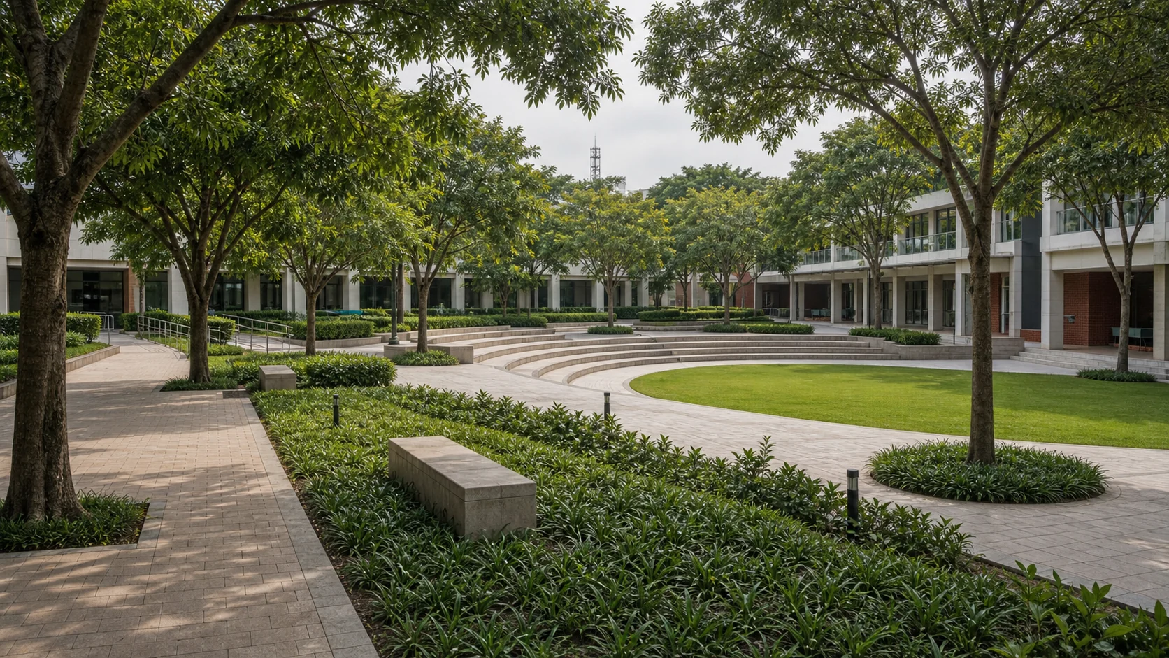 Institutional campus landscape with lawns, shaded walkways, and durable student-friendly outdoor spaces.