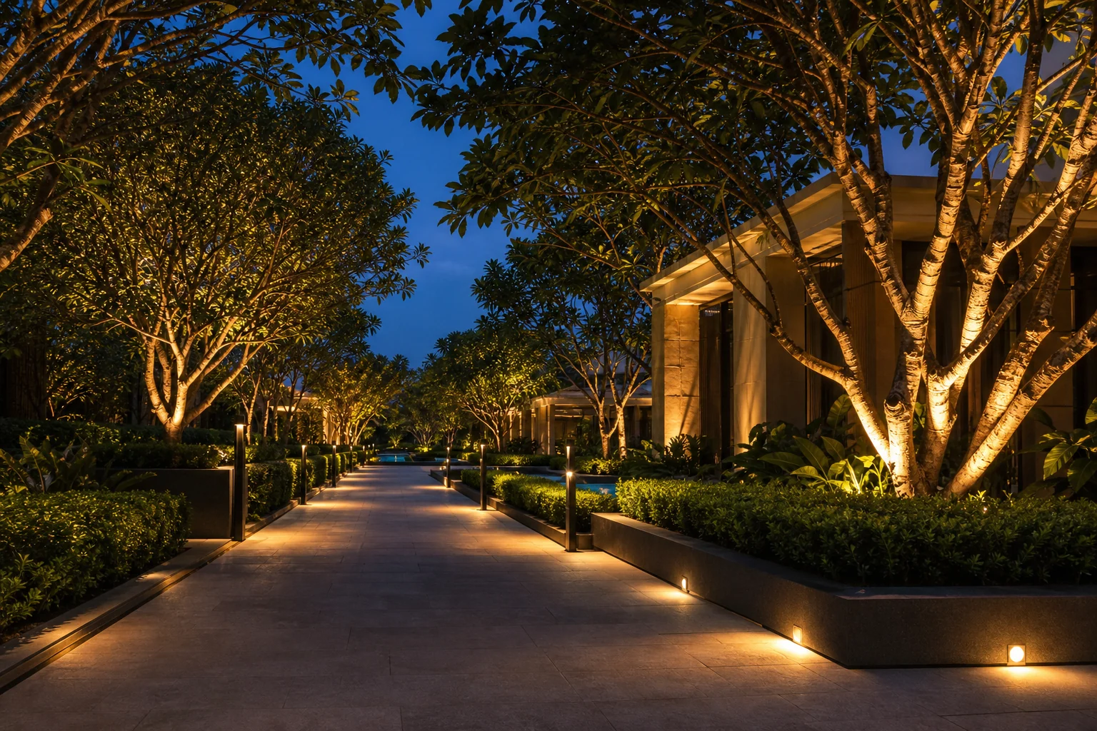 Outdoor landscape lighting along a planted garden walkway with warm path lights and safe evening circulation.