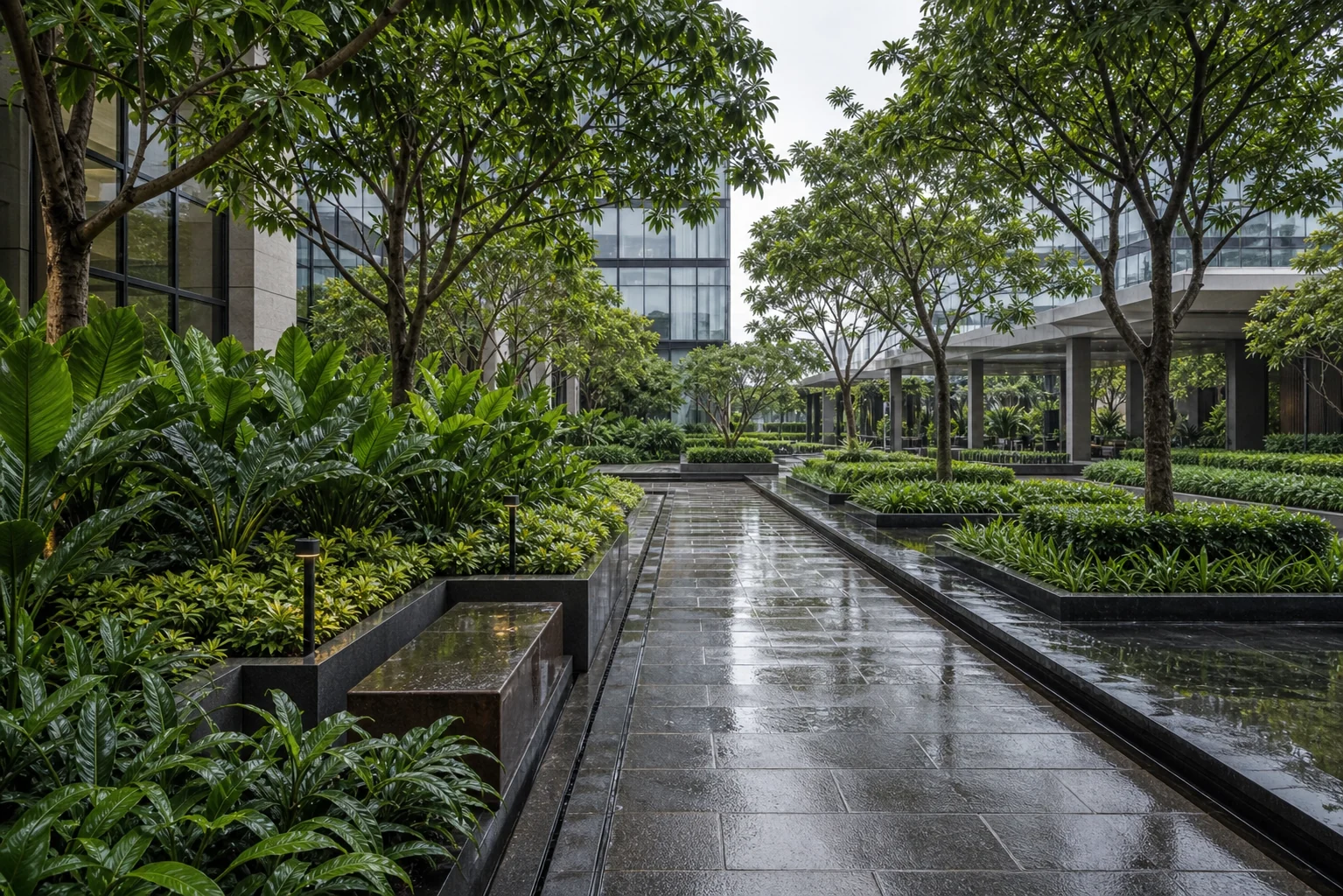 Lush monsoon-ready campus landscape with shaded walkway, layered planting, and water-resilient hardscape edges.