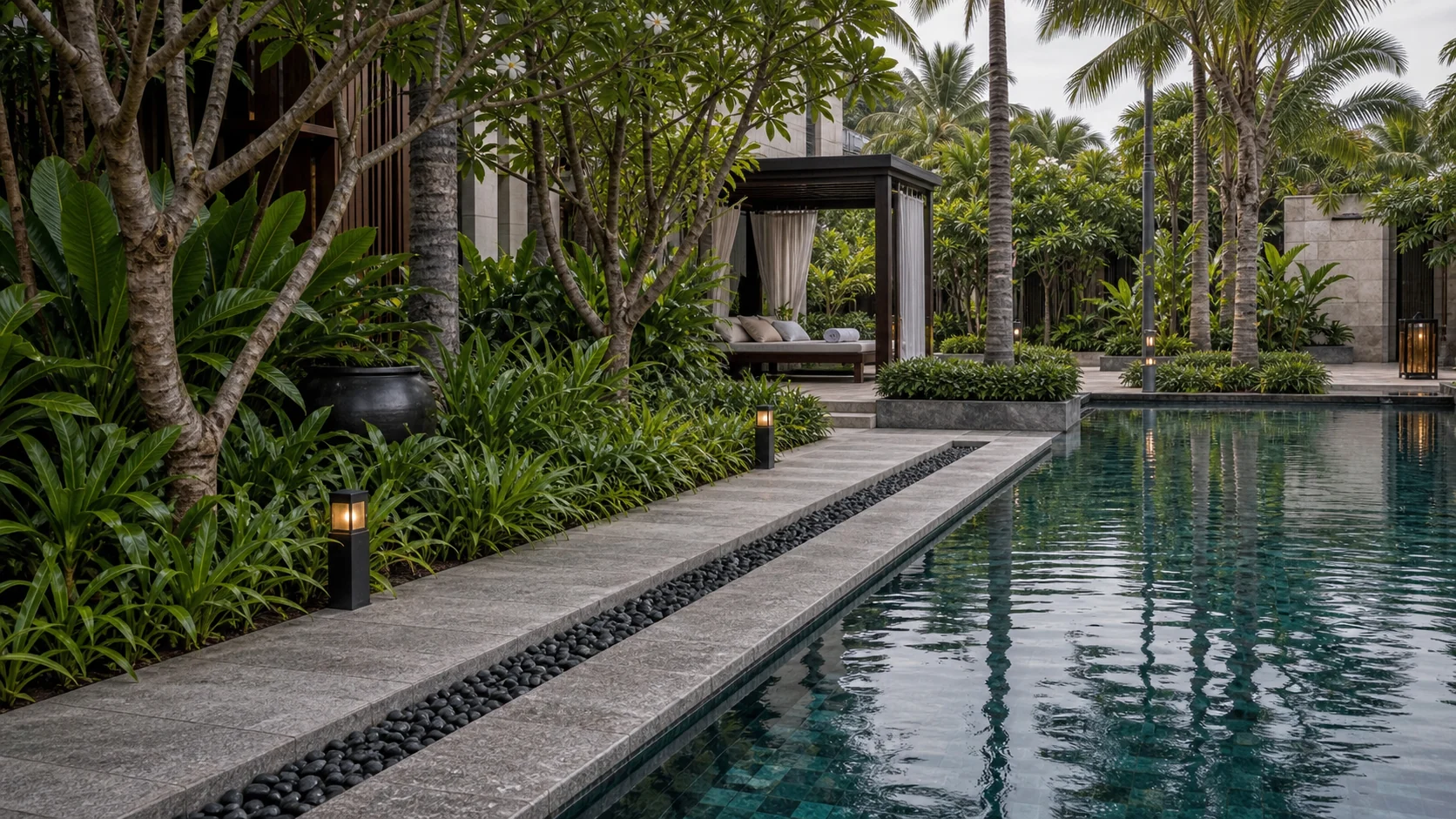Resort pool landscape with tropical planting, deck edge, and premium leisure amenity setting.