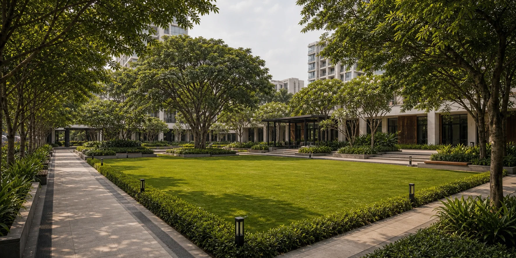 Hotel arrival court with granite paving, planter edges, and shaded pedestrian circulation.