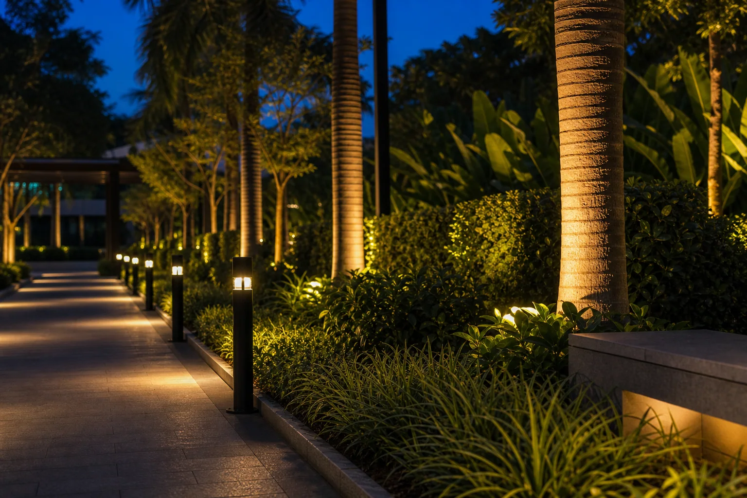 Tree uplighting in a commercial garden with shielded low-glare LED fixtures at evening.