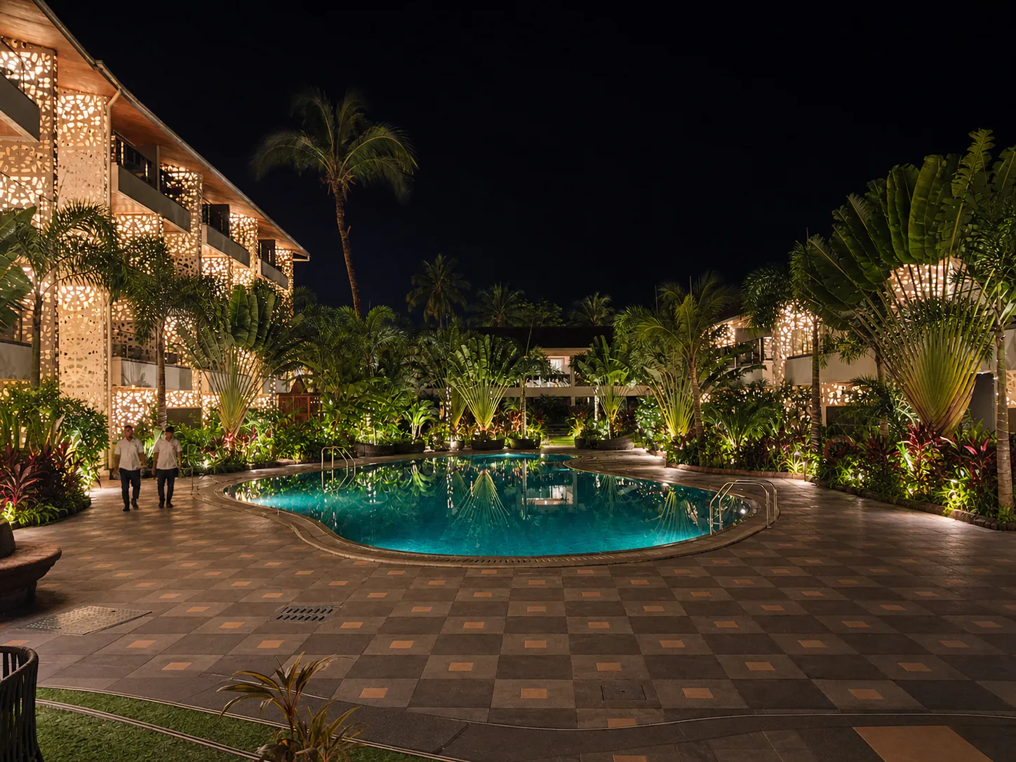 Hyatt Place Goa Candolim frontal night view across the illuminated swimming pool and tropical facade garden