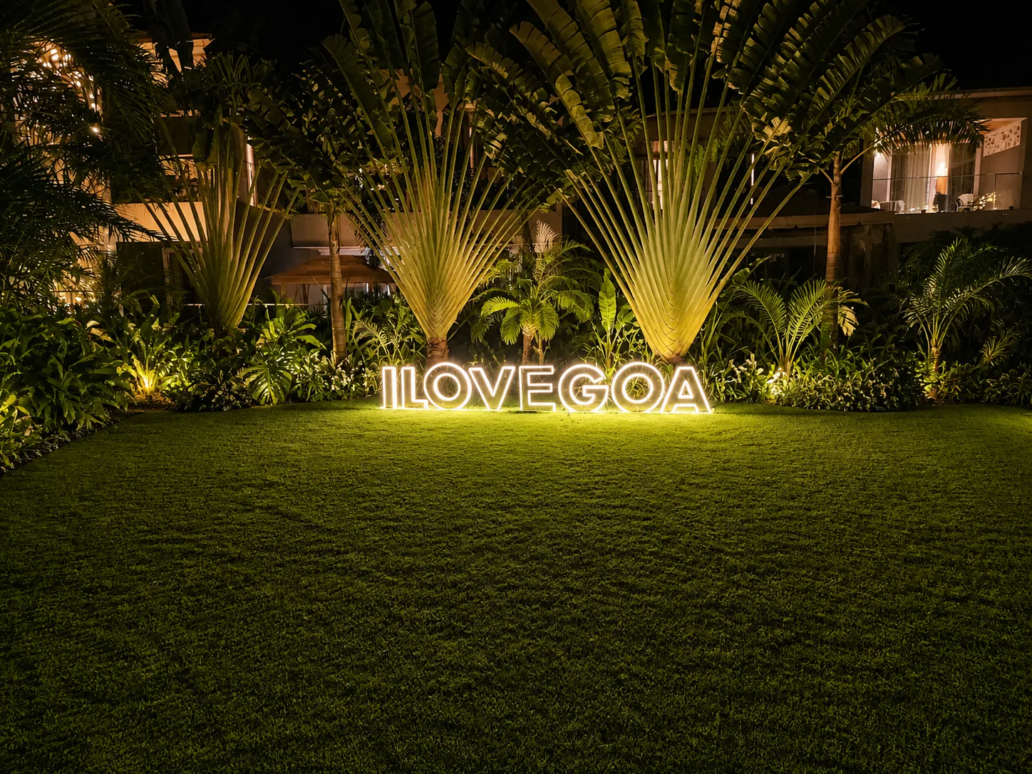 Hyatt Place Goa Candolim illuminated I LOVE GOA lawn framed by traveller palms and tropical planting