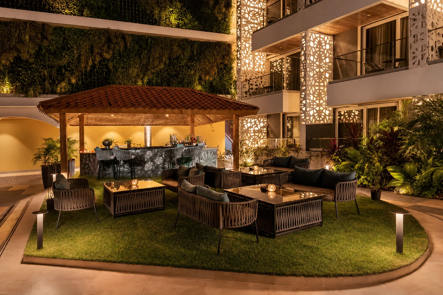 Hyatt Place Goa Candolim five-star courtyard lounge with manicured grass, outdoor seating and warm lighting