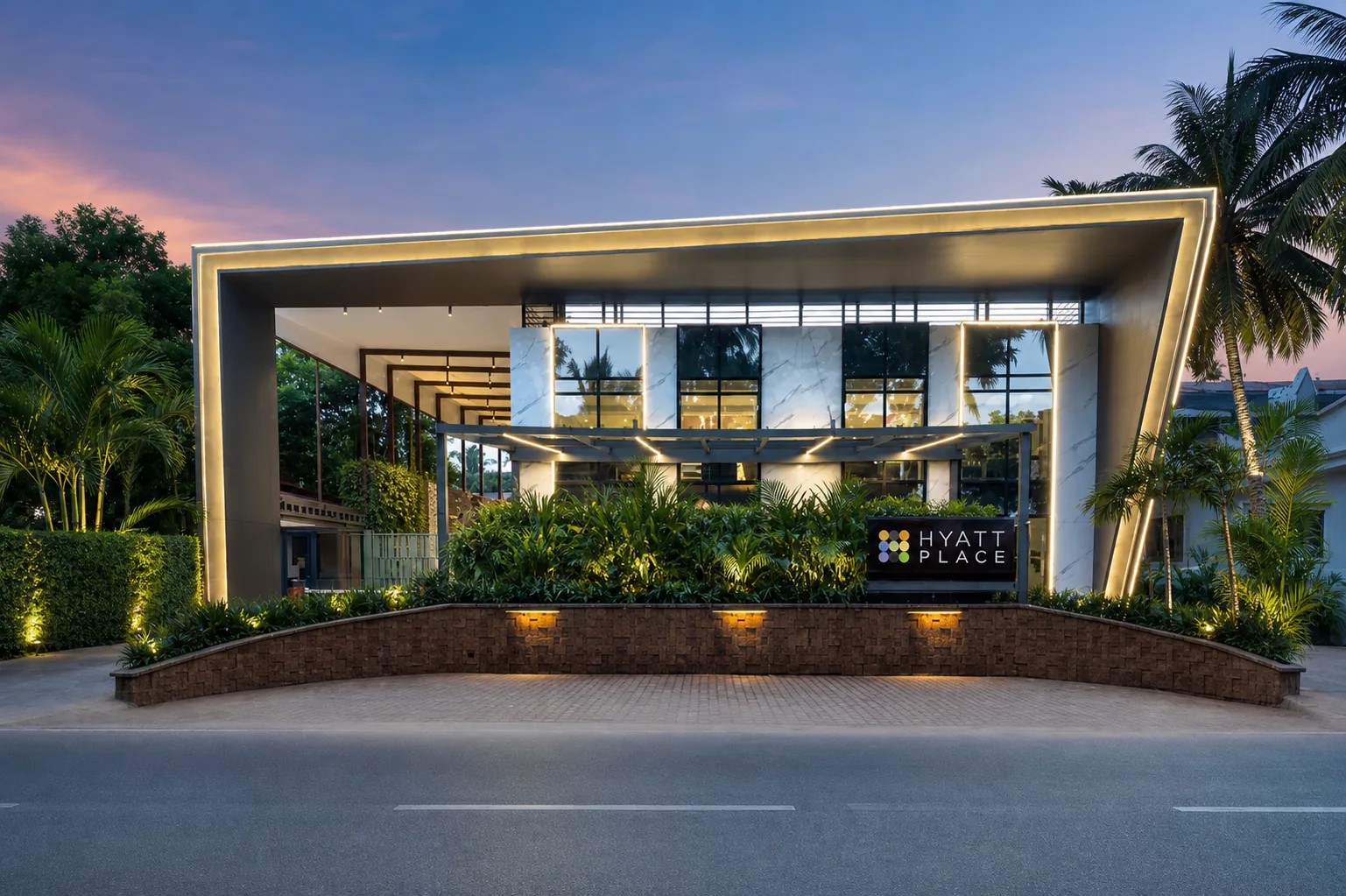 Hyatt Place Goa Candolim arrival pavilion at blue hour with hotel sign and formal tropical planting