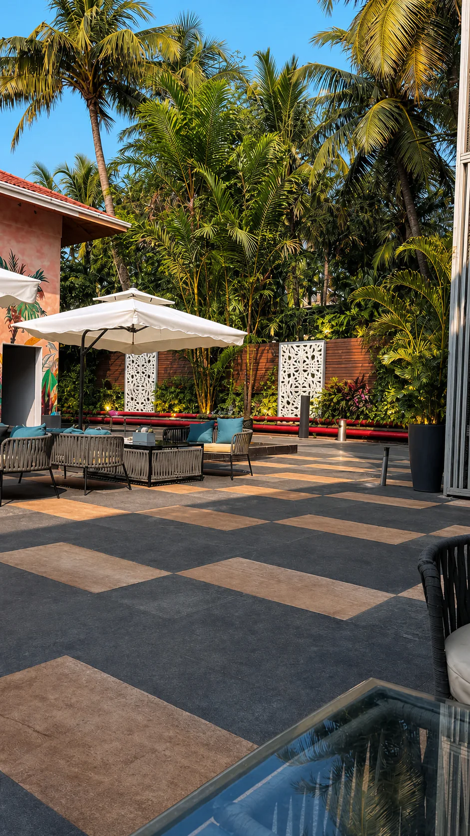 Hyatt Place Goa Candolim tropical dining terrace with white umbrellas, premium paving and layered palms