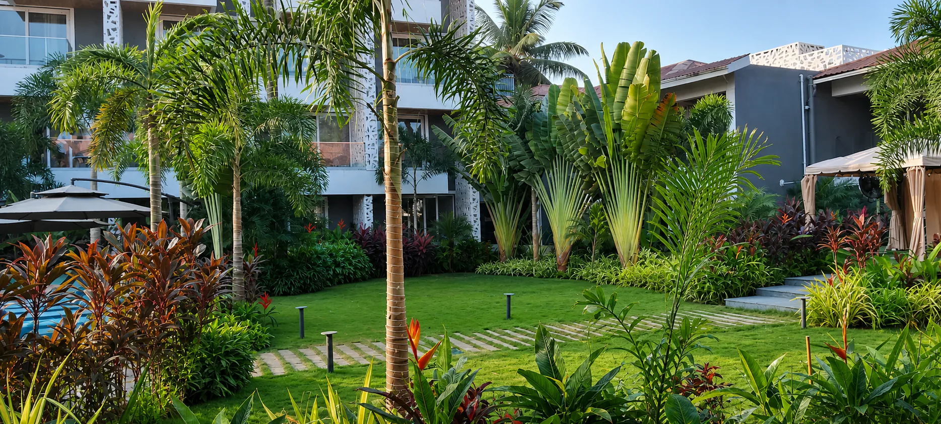 Hyatt Place Goa Candolim panoramic lawn garden with traveller palms, foxtails and layered foliage