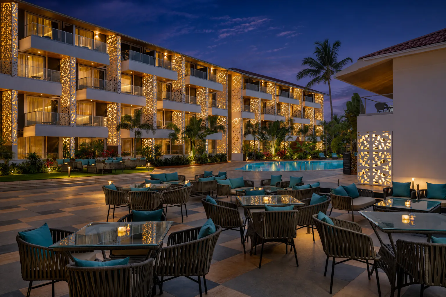 Hyatt Place Goa Candolim twilight dining terrace overlooking the pool and glowing jali guest-room facade