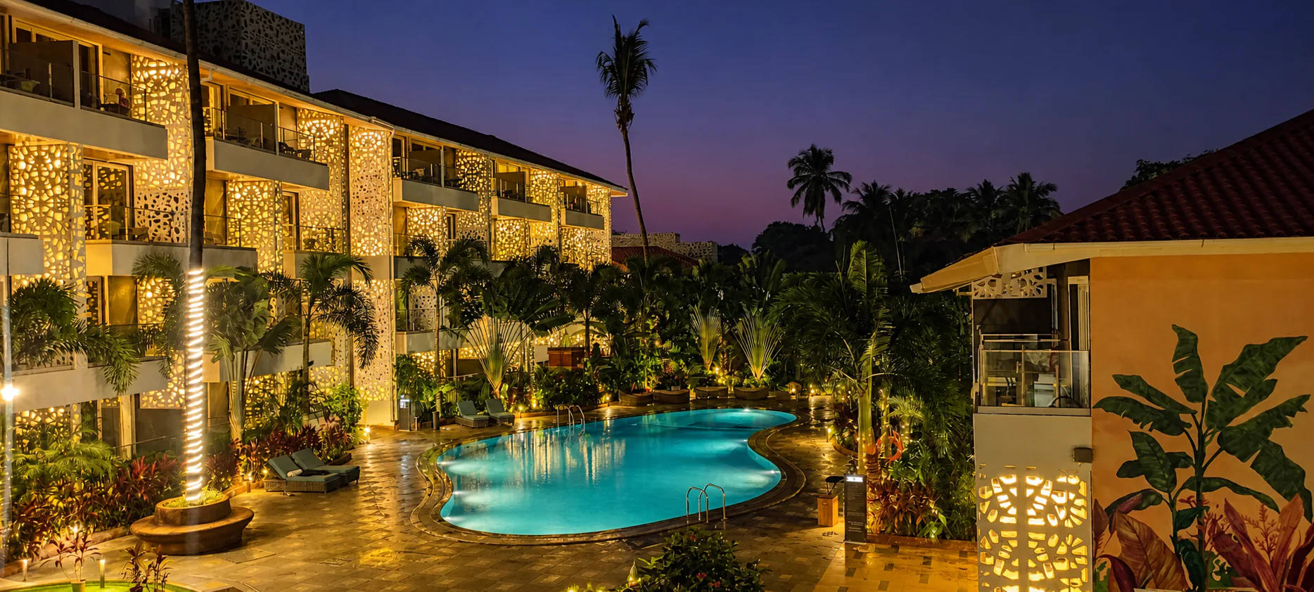 Hyatt Place Goa Candolim twilight pool and mural courtyard with warm lights and tropical greenery