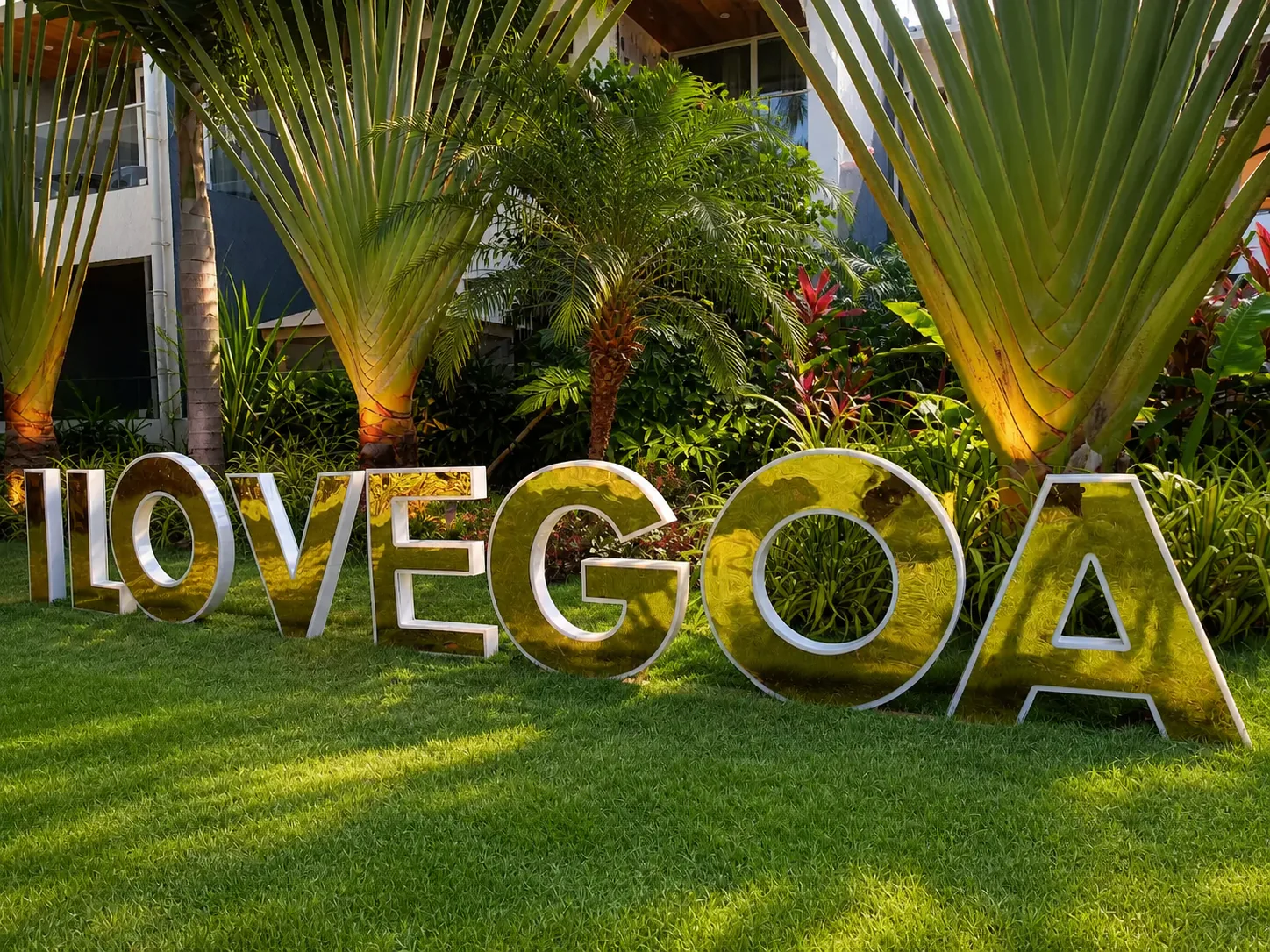 Hyatt Place Goa Candolim polished I LOVE GOA feature on manicured lawn beneath traveller palms