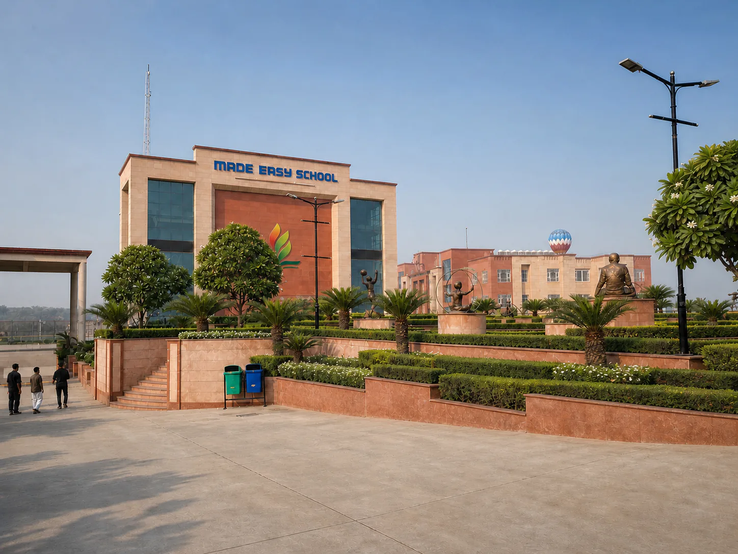 Made Easy School Bhandwari straightened arrival court with sculpture terrace, clipped hedges, palms and restrained flowering plants