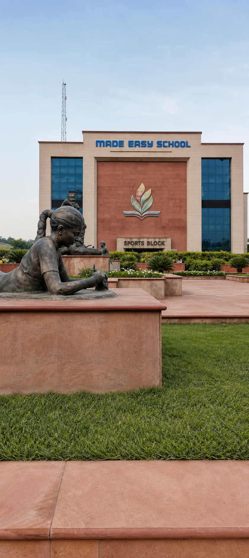 Made Easy School Bhandwari bronze girl sculpture in a landscaped garden facing the Made Easy School Sports Block