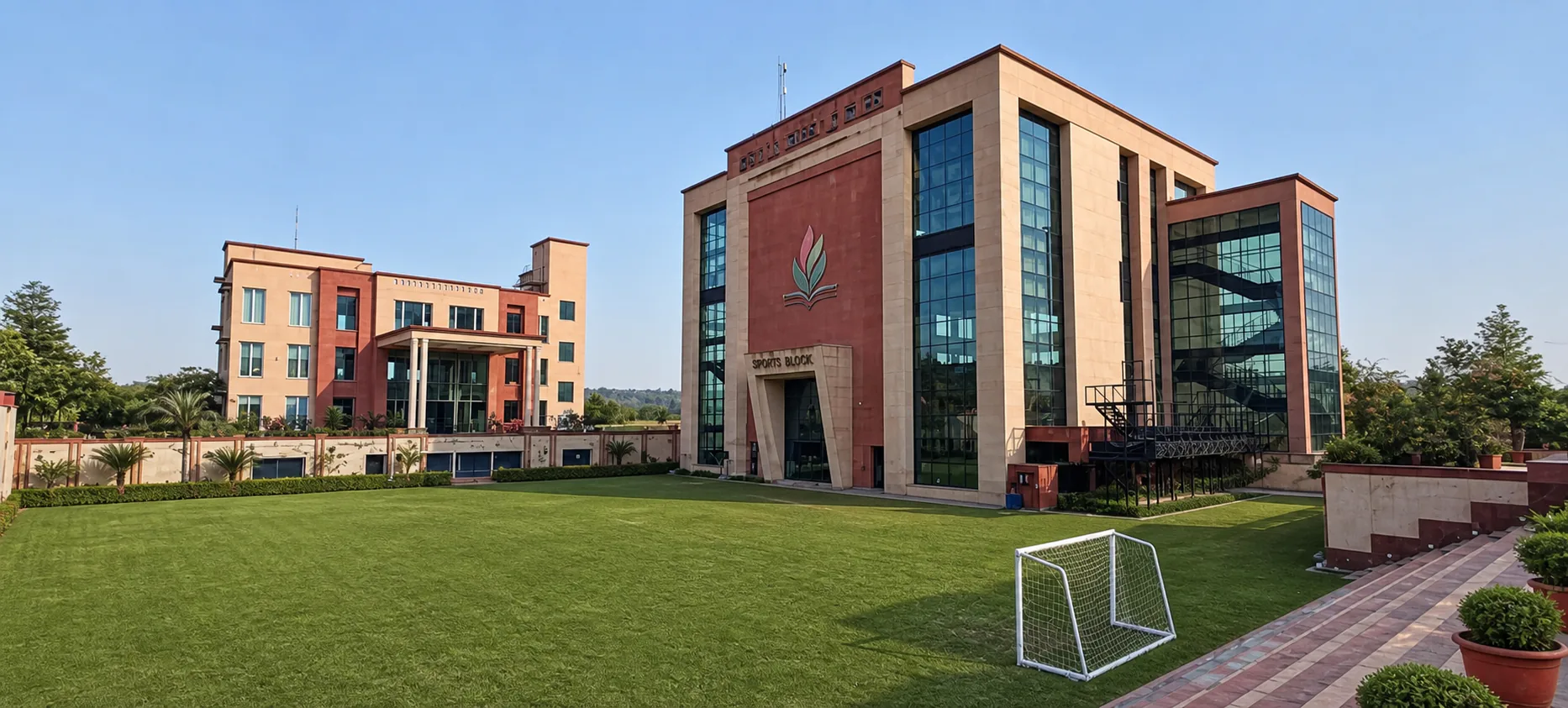 Made Easy School Bhandwari wide natural sports lawn facing the Sports Block and academic building with formal perimeter planting