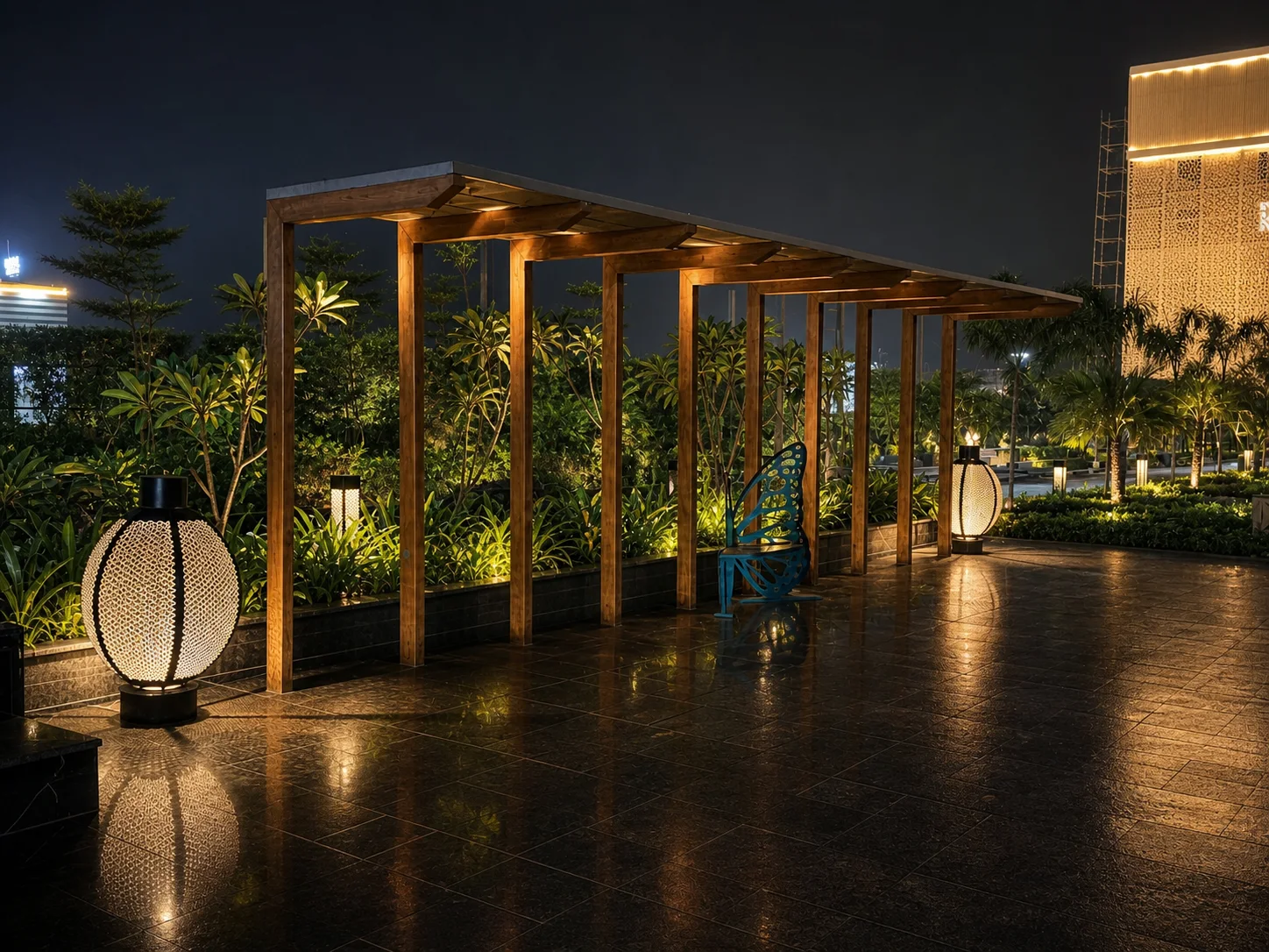 One Farrer timber garden pergola at night with layered tropical planting and warm integrated landscape lighting.