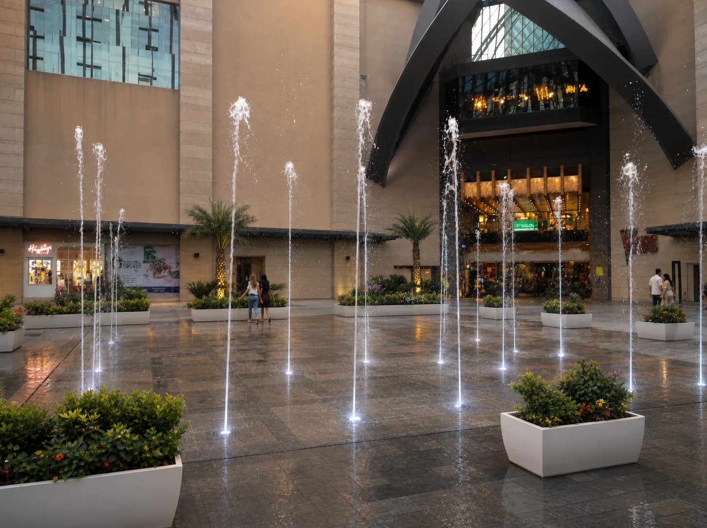 Vegas Mall Dwarka fountain plaza with illuminated jets, geometric planters and compact palms