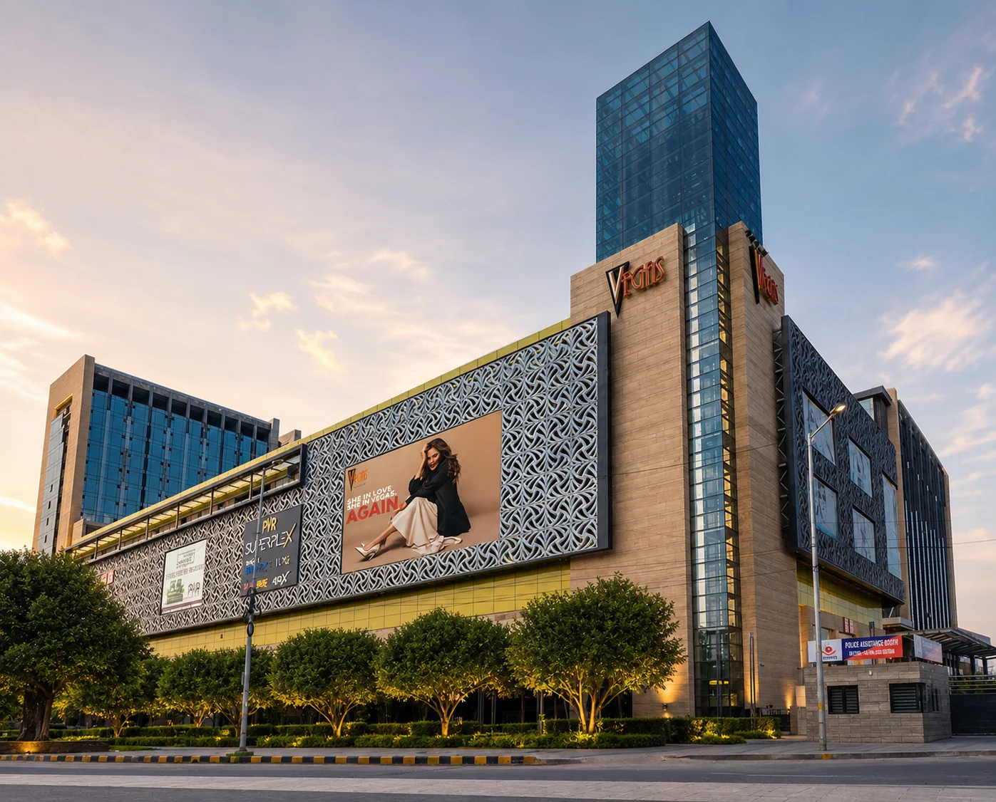 Vegas Mall Dwarka exterior at golden hour with structured street trees, layered frontage planting and preserved facade signage.