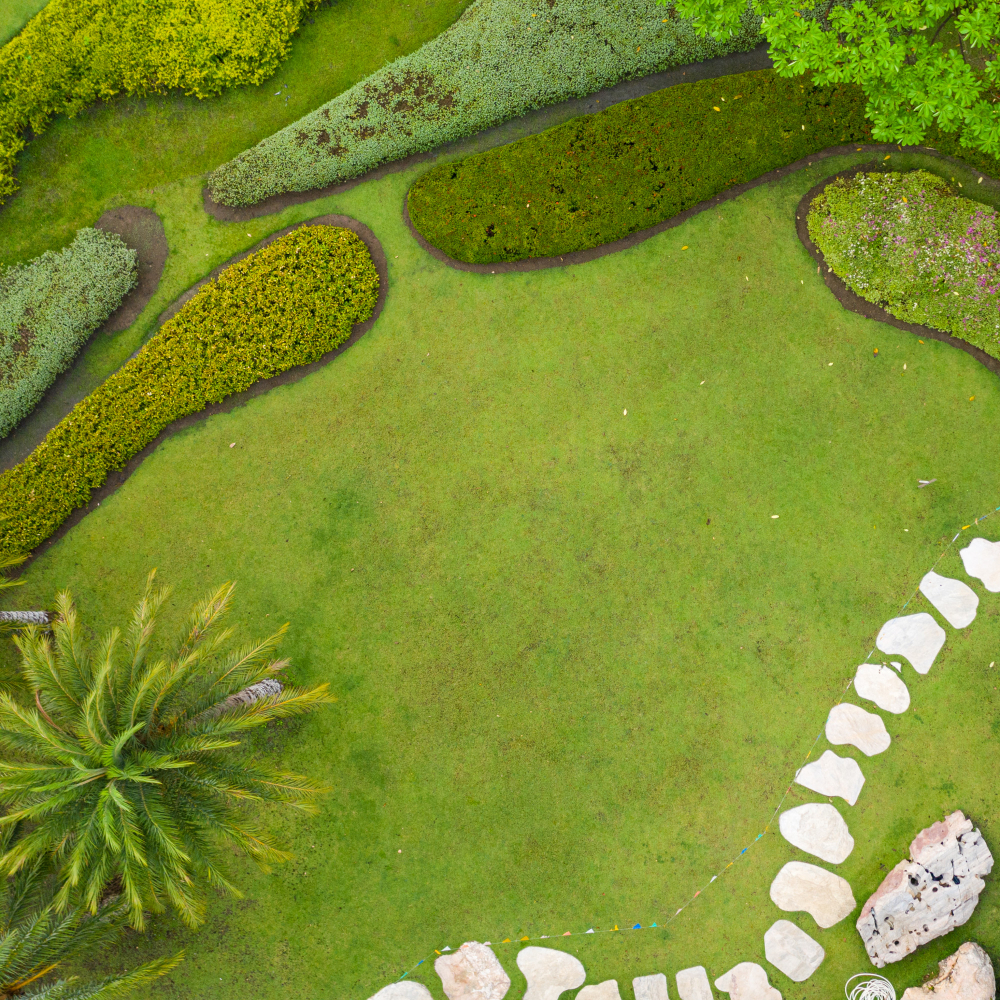 Aerial view of a meticulously landscaped garden by Four Leaf Landscape featuring lush greenery and winding pathways, showcasing their horticulture and softscape landscaping expertise in India.