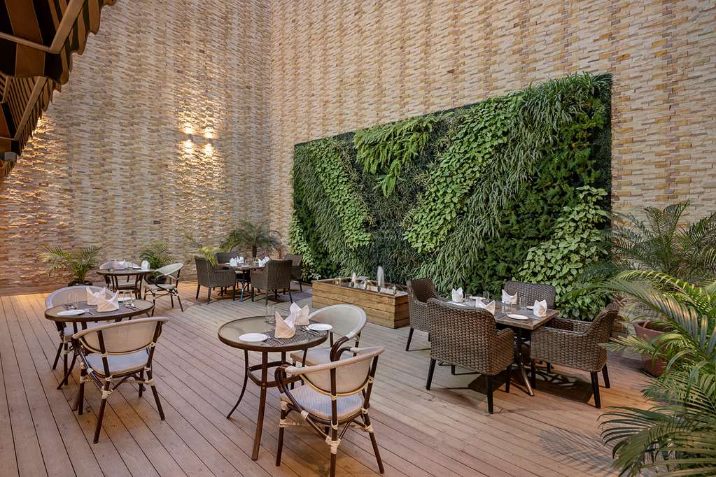 Country Inn & Suites Zirakpur's dining area with Four Leaf Landscape's vertical garden design.
